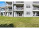 View of the exterior with patios overlooking a lush green lawn at 13839 Fairway Island Dr # 1116, Orlando, FL 32837