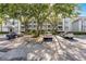 Exterior of a condo building with a parking lot featuring multiple cars and trees at 13839 Fairway Island Dr # 1116, Orlando, FL 32837