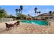 Resort-style community pool with lounge seating and mature palm trees at 13839 Fairway Island Dr # 1116, Orlando, FL 32837