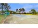 Fenced in community tennis court surrounded by mature trees and landscaping at 13839 Fairway Island Dr # 1116, Orlando, FL 32837
