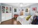 Bright bedroom featuring hardwood floors, two windows, and bookshelves at 1421 N Hampton Ave, Orlando, FL 32803