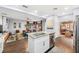 Open-concept kitchen with stainless steel appliances, island seating and sightlines to living room at 1421 N Hampton Ave, Orlando, FL 32803