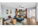 Inviting living room featuring hardwood floors, eclectic decor, and natural light from the windows at 1421 N Hampton Ave, Orlando, FL 32803