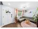 Bright living room features hardwood floors, a cozy green sectional, and stylish decor at 1421 N Hampton Ave, Orlando, FL 32803