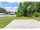 Spacious backyard featuring a well-maintained lawn, a concrete patio, and a surrounding privacy fence at 14878 Se 32Nd Ter, Summerfield, FL 34491