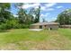 Large, grassy backyard featuring a small concrete patio, ideal for enjoying the outdoors at 14878 Se 32Nd Ter, Summerfield, FL 34491