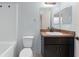 Bathroom featuring a dark vanity with a white sink and a matching granite countertop at 14878 Se 32Nd Ter, Summerfield, FL 34491