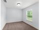 This bedroom offers a bright space with neutral walls, carpet, and a window that brings in plenty of light at 14878 Se 32Nd Ter, Summerfield, FL 34491