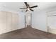 A clean bedroom includes a ceiling fan and a closet perfect for additional storage at 14878 Se 32Nd Ter, Summerfield, FL 34491