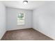 This bedroom is bright, and simple with a window providing natural light, creating a serene atmosphere at 14878 Se 32Nd Ter, Summerfield, FL 34491