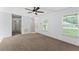 Inviting living room featuring plush carpet flooring and ample natural light at 14878 Se 32Nd Ter, Summerfield, FL 34491
