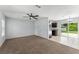 Inviting living room with a ceiling fan, and access to a tiled dining area and kitchen at 14878 Se 32Nd Ter, Summerfield, FL 34491