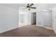 Open living space with carpet, a ceiling fan, and easy access to other rooms at 14878 Se 32Nd Ter, Summerfield, FL 34491
