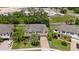 Aerial view of a two-story house with red shutters and a brick driveway in a residential area at 15242 Heron Hideaway Cir, Winter Garden, FL 34787