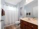 Bathroom featuring a tub with shower, vanity, and neutral decor at 15242 Heron Hideaway Cir, Winter Garden, FL 34787