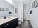 Bathroom featuring modern vanity, artistic decor, and access to the outdoors at 15242 Heron Hideaway Cir, Winter Garden, FL 34787