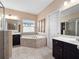 Bright bathroom with soaking tub, double vanity, and glass shower at 15242 Heron Hideaway Cir, Winter Garden, FL 34787