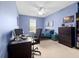 Cozy blue bedroom with a desk, a bed, a chest of drawers, and ample natural light at 15242 Heron Hideaway Cir, Winter Garden, FL 34787