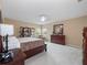 Bedroom featuring a dark wood dresser and bed set, neutral carpeting and a large bright window at 15242 Heron Hideaway Cir, Winter Garden, FL 34787