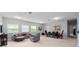 Bonus room with neutral carpeting, offering a seating area and dining space for flexible living at 15242 Heron Hideaway Cir, Winter Garden, FL 34787
