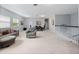 Large bonus room offering versatile living space with a comfortable seating area, dining set, and neutral carpeting at 15242 Heron Hideaway Cir, Winter Garden, FL 34787