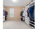 Spacious walk-in closet with custom shelving and ample storage space at 15242 Heron Hideaway Cir, Winter Garden, FL 34787