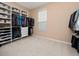 Walk-in closet with custom shelving and ample storage space at 15242 Heron Hideaway Cir, Winter Garden, FL 34787