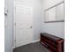 Inviting entryway with a mirrored wall, door and shoe storage bench with padded seat at 15242 Heron Hideaway Cir, Winter Garden, FL 34787