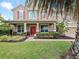 Beautiful two-story home with red door and shutters and well-manicured landscaping at 15242 Heron Hideaway Cir, Winter Garden, FL 34787