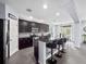 Modern kitchen with stainless steel appliances, granite countertops, and a breakfast bar with seating at 15242 Heron Hideaway Cir, Winter Garden, FL 34787