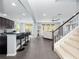 Open-concept kitchen and living area featuring a breakfast bar and a staircase leading to the second floor at 15242 Heron Hideaway Cir, Winter Garden, FL 34787