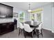 Eat-in kitchen featuring dark wood cabinets, stainless appliances, modern backsplash, and a table with seating for six at 15242 Heron Hideaway Cir, Winter Garden, FL 34787