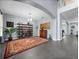 Bright living room featuring neutral walls, modern shelving, large accent rug, and lots of natural light at 15242 Heron Hideaway Cir, Winter Garden, FL 34787