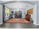 Open living room with neutral walls, accent rug, modern shelving, and large window for natural light at 15242 Heron Hideaway Cir, Winter Garden, FL 34787
