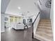 Spacious living room with staircase, modern sectional sofa, and abundant natural light from the rear windows at 15242 Heron Hideaway Cir, Winter Garden, FL 34787