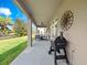 Covered patio with ceiling fan, grill, and view of the backyard, perfect for entertaining at 15242 Heron Hideaway Cir, Winter Garden, FL 34787