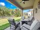 Comfortable covered patio featuring a seating area and view of the yard, ideal for relaxing outdoors at 15242 Heron Hideaway Cir, Winter Garden, FL 34787
