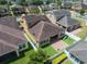 An aerial perspective showcasing a backyard with a lawn, patio, privacy fence, and outdoor play equipment at 15443 Sugarcup Ct, Orlando, FL 32828