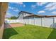 Fenced backyard features a playset, patio area, and lush green grass at 15443 Sugarcup Ct, Orlando, FL 32828