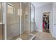 Bathroom featuring a glass shower with tile surround, and access to the walk-in closet at 15443 Sugarcup Ct, Orlando, FL 32828