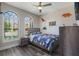 Charming bedroom with dinosaur decor, hardwood floors, and lots of natural light at 15443 Sugarcup Ct, Orlando, FL 32828