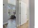 View of a modern bedroom with gray walls and arched windows through a door at 15443 Sugarcup Ct, Orlando, FL 32828