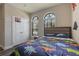 Well-lit bedroom with dinosaur decor, window shutters, and ample space at 15443 Sugarcup Ct, Orlando, FL 32828