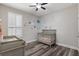 Bedroom with hardwood floors, a crib, and lovely décor accents at 15443 Sugarcup Ct, Orlando, FL 32828
