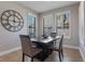 Charming dining room with a dark table, four chairs, and three windows covered by white shutters at 15443 Sugarcup Ct, Orlando, FL 32828