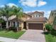 Attractive home boasts a well-manicured lawn, paver driveway, mature trees and a two-car garage at 15443 Sugarcup Ct, Orlando, FL 32828