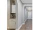 Hallway boasts tiled flooring, white trim, an arched entryway and a built in cabinet at 15443 Sugarcup Ct, Orlando, FL 32828