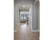 Bright hallway featuring tiled floors, an archway and partial view of the living room at 15443 Sugarcup Ct, Orlando, FL 32828