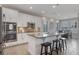 Spacious kitchen with white cabinets, an island with seating, and modern appliances at 15443 Sugarcup Ct, Orlando, FL 32828