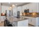 Modern white kitchen with a large island, stainless steel appliances, and decorative pendant lights at 15443 Sugarcup Ct, Orlando, FL 32828